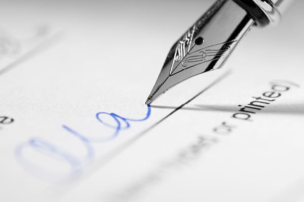 A pen adding in a signature.