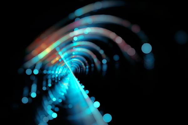 Abstract light tunnel featuring blue and red lights, included in the Ahead of the Deal M&A Briefing article series.